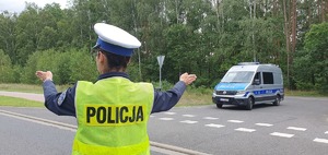 Policjantka wydziału ruchu drogowego zatrzymuje pojazd do kontroli drogowej.